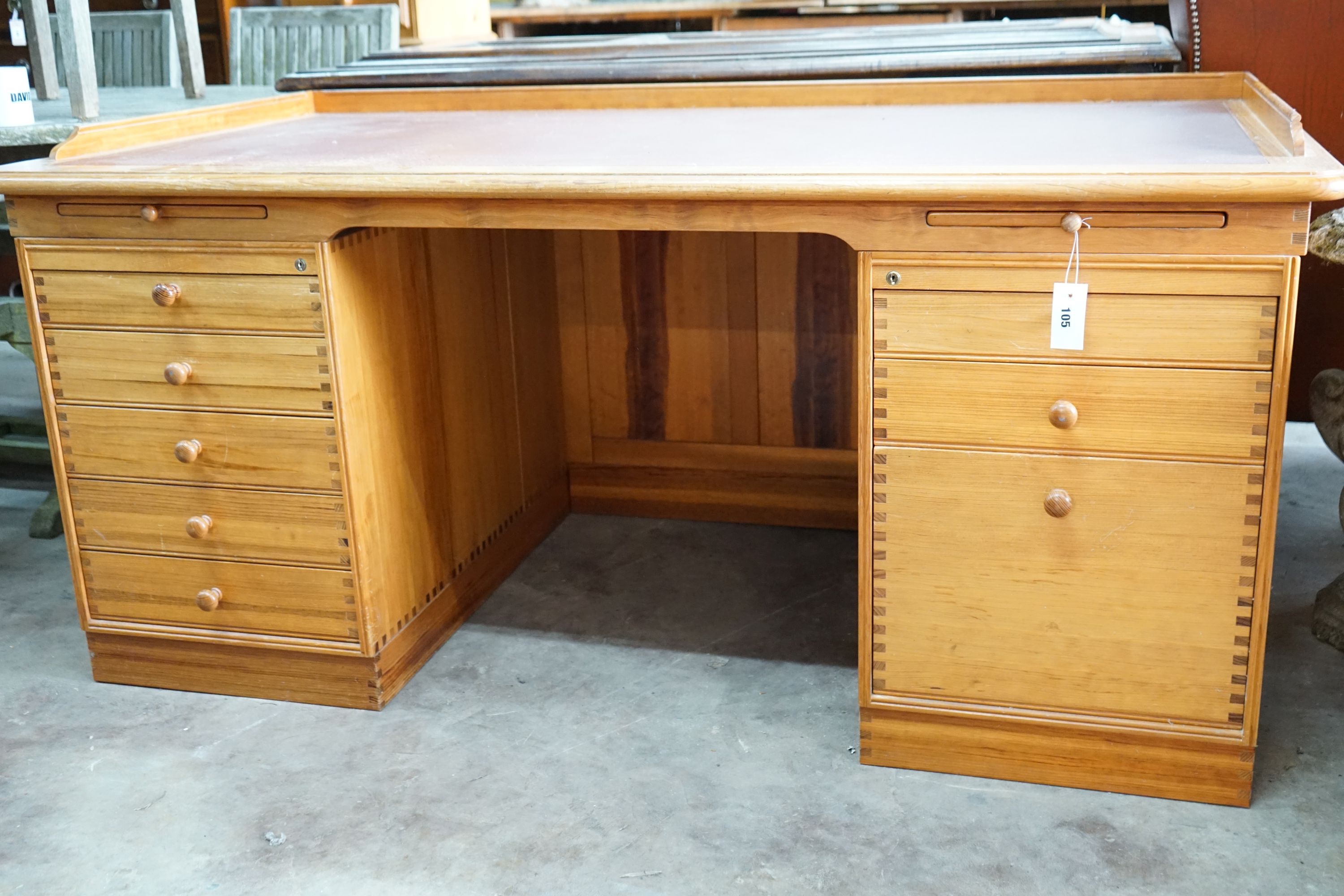 A Finn Hansen Danish pine kneehole pedestal desk with opposing drawers and cupboards, length 168cm, depth 88cm, height 78cm